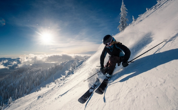 A woman snowboarding in the mountains