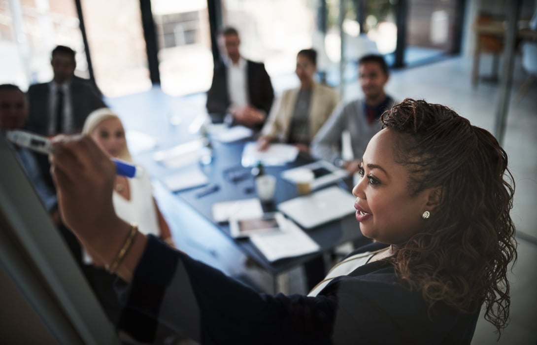 A woman leading a boardroom meeting