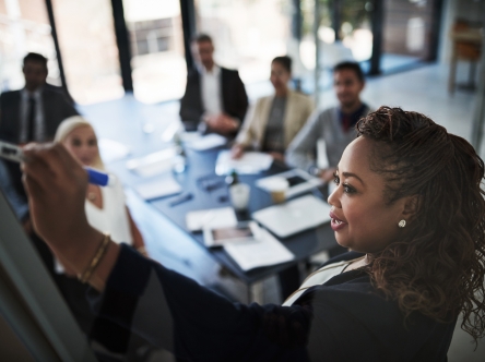 A woman leading a boardroom meeting