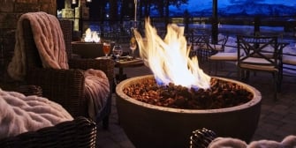 Stone fire pit next to the patio chairs