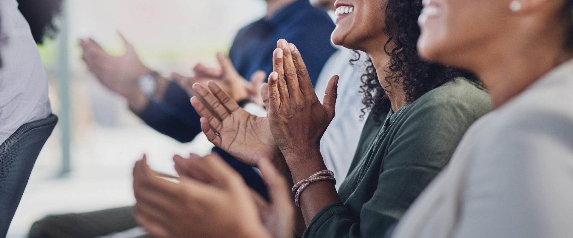 A group of people clapping hands