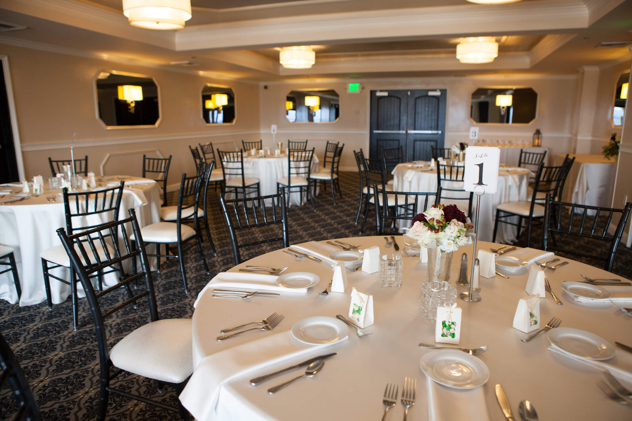 A dining room with round tables set for a meal.