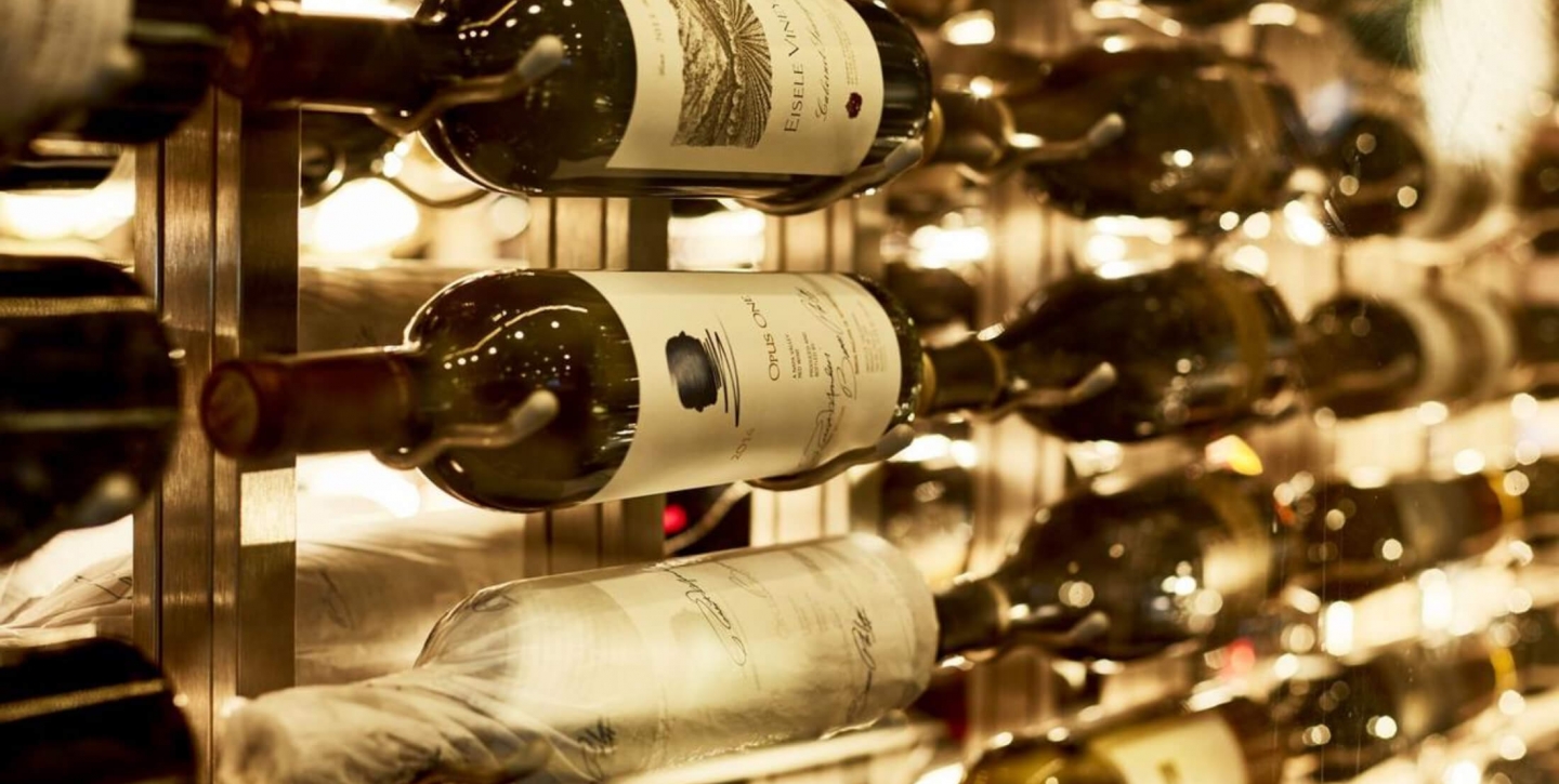 Close up of wine bottles on a wooden wine rack