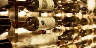 Close up of wine bottles on a wooden wine rack