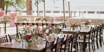 Wedding dinner venue with flowers on the water