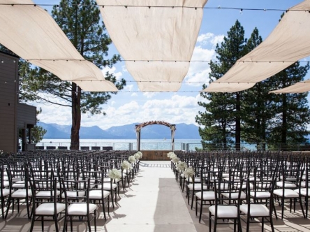 Wedding ceremony venue with empty chairs on the water