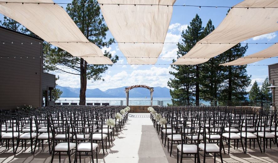 Wedding ceremony venue with empty chairs on the water