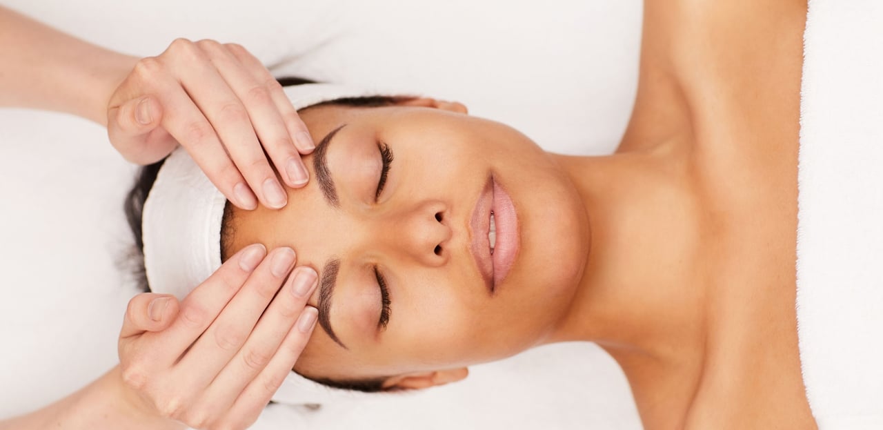A woman receiving a facial treatment.