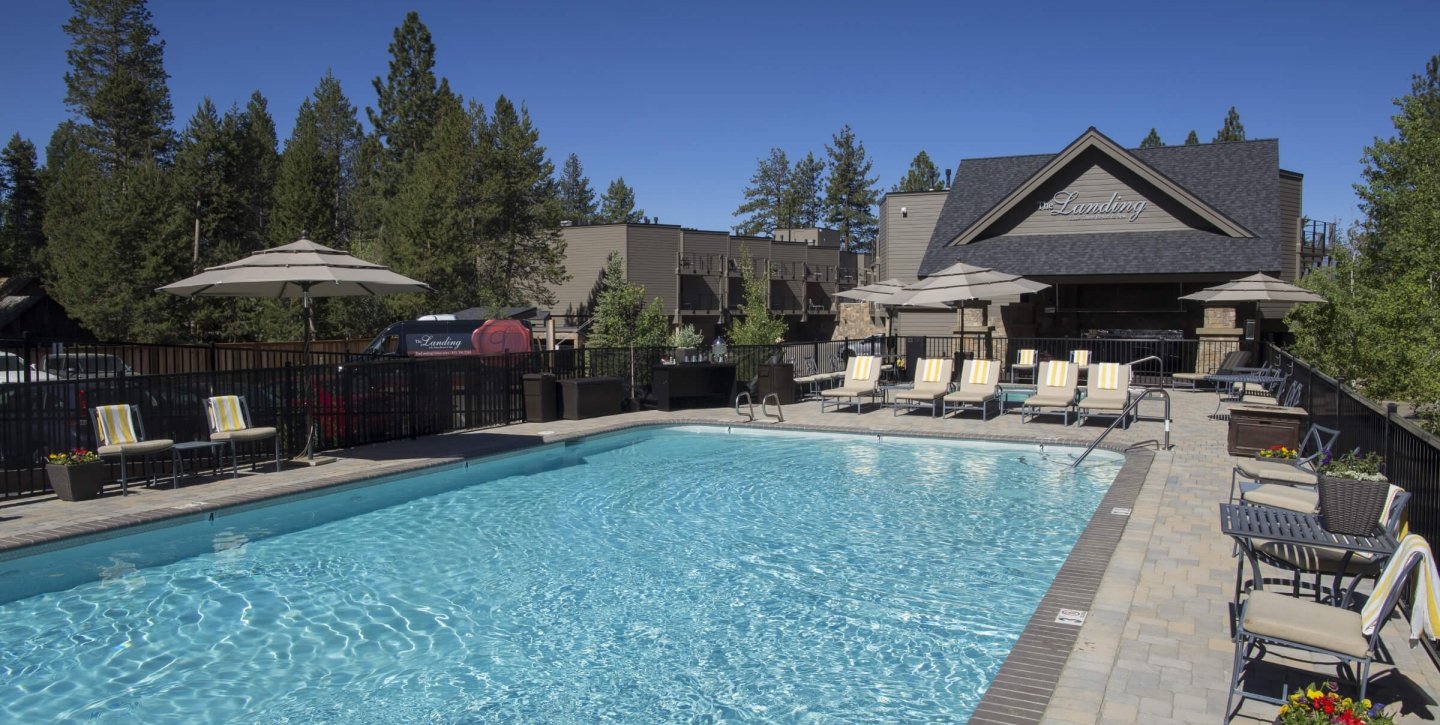 The landing building overlooking an outdoor pool next to the lounge chairs
