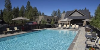 The landing building overlooking an outdoor pool next to the lounge chairs