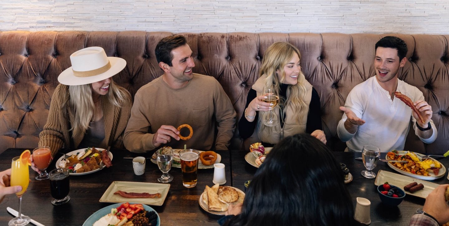 Group of friends laughing at dinner