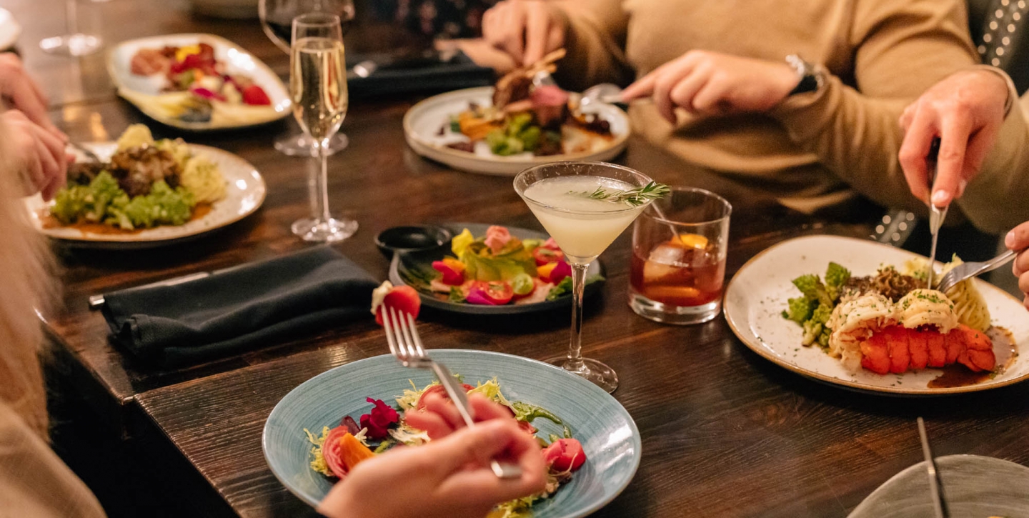 Close up of a group of friends meals at a restaurant