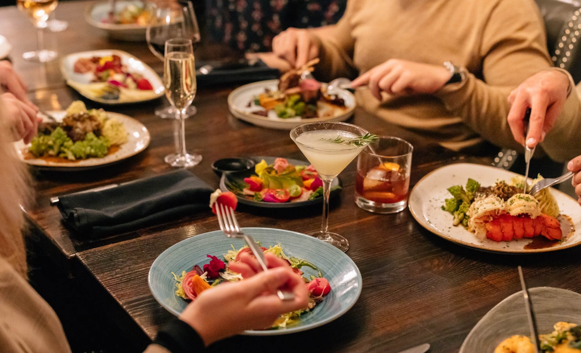 Close up of a group of friends meals at a restaurant