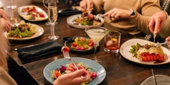 Close up of a group of friends meals at a restaurant