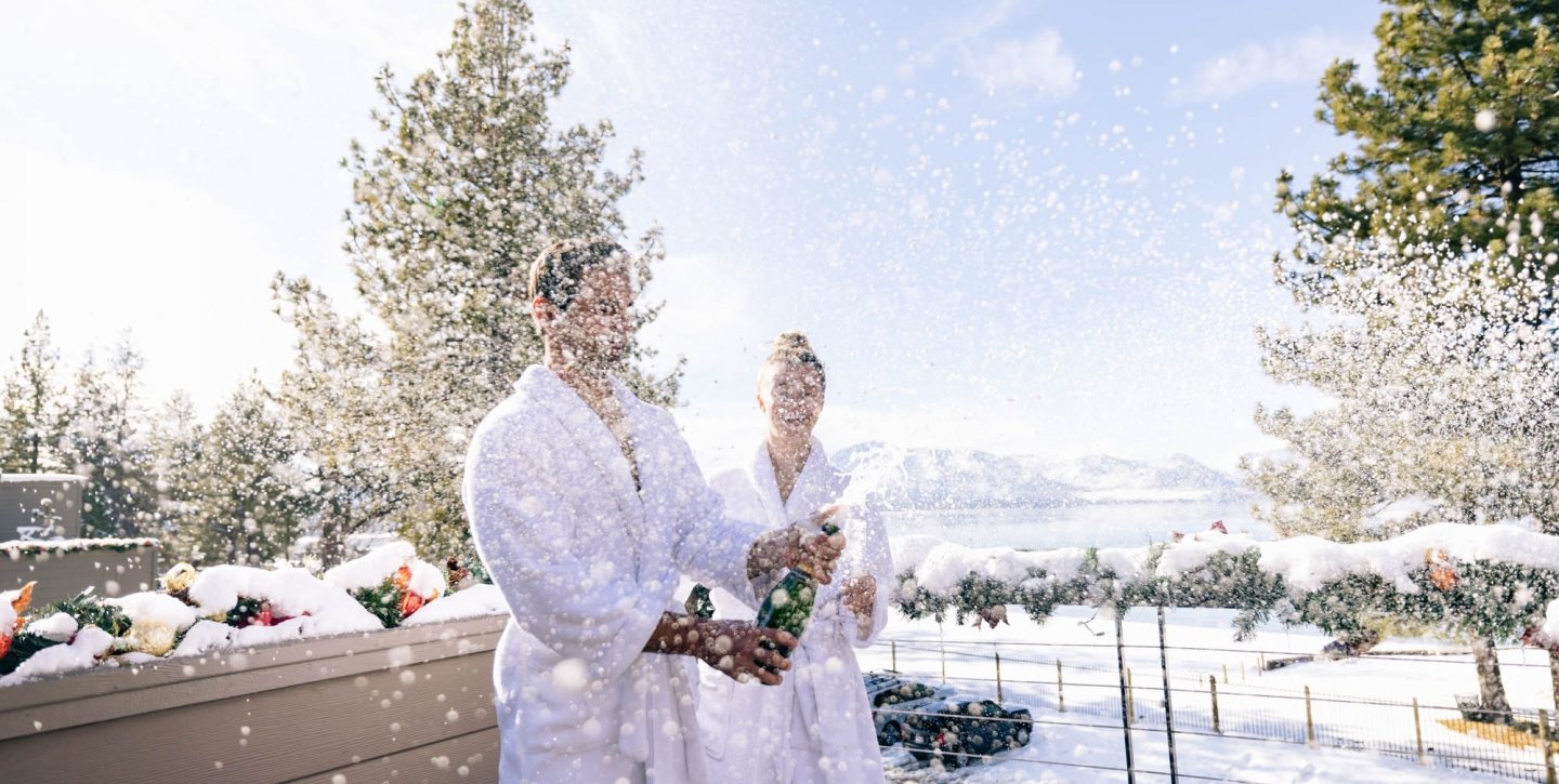 Couple outside spraying champagne