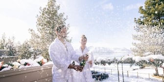 Couple outside spraying champagne