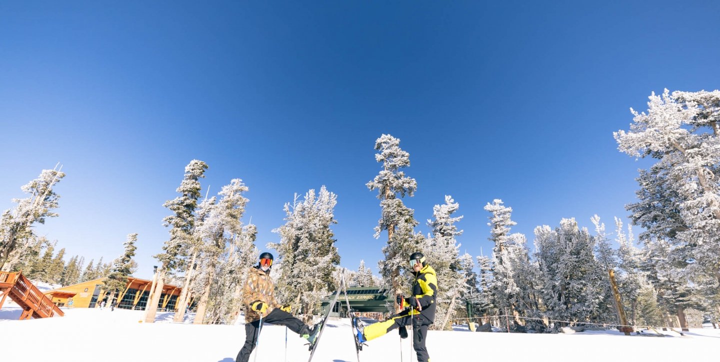 Two friends outside in the snow skiing