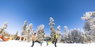 Two friends outside in the snow skiing