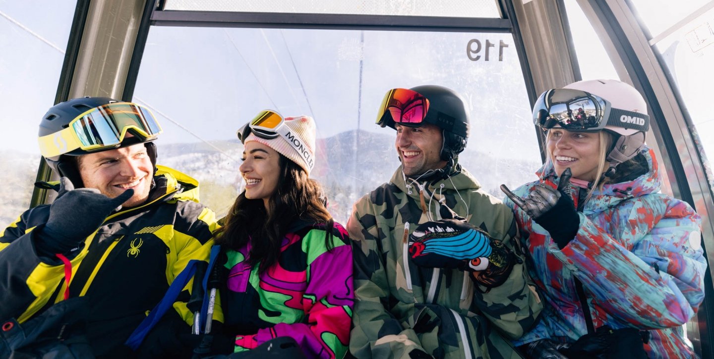 Group of friends laughing on a ski lift
