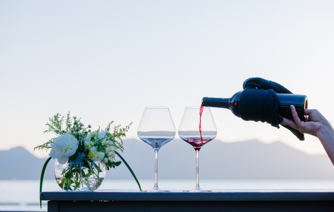 Wine pour with a Lake and Mountain backdrop
