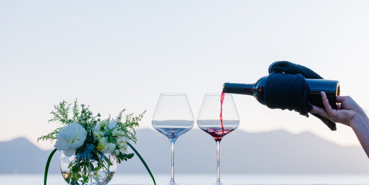 Wine pour with a Lake and Mountain backdrop