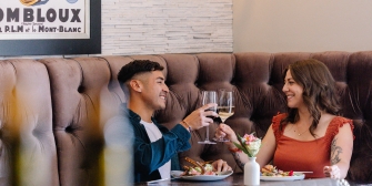 A couple enjoying food and drinks