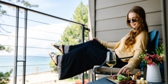 Guest enjoying charcuterie and lakefront views