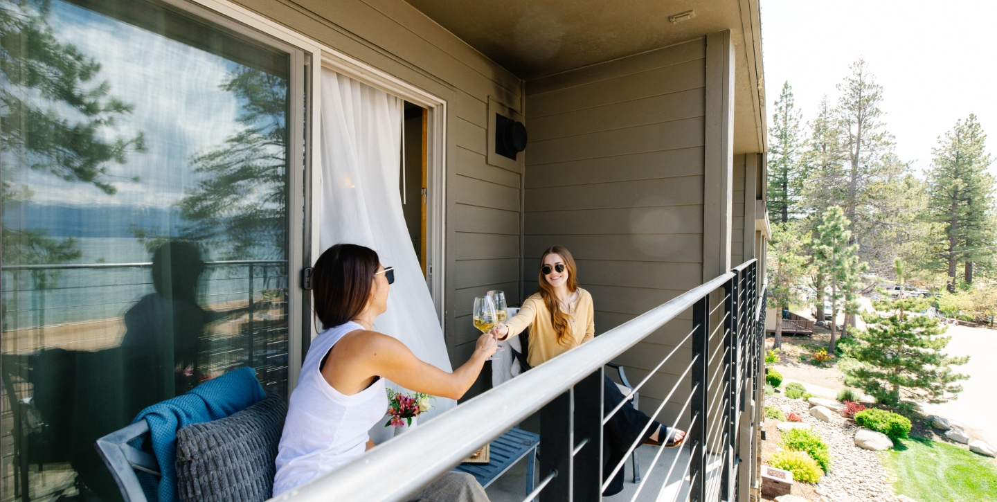 Guests enjoying wine on their private balcony