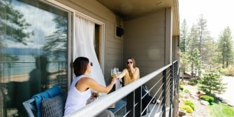 Guests enjoying wine on their private balcony