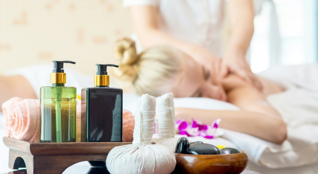 a spa treatment in progress with a woman receiving a massage