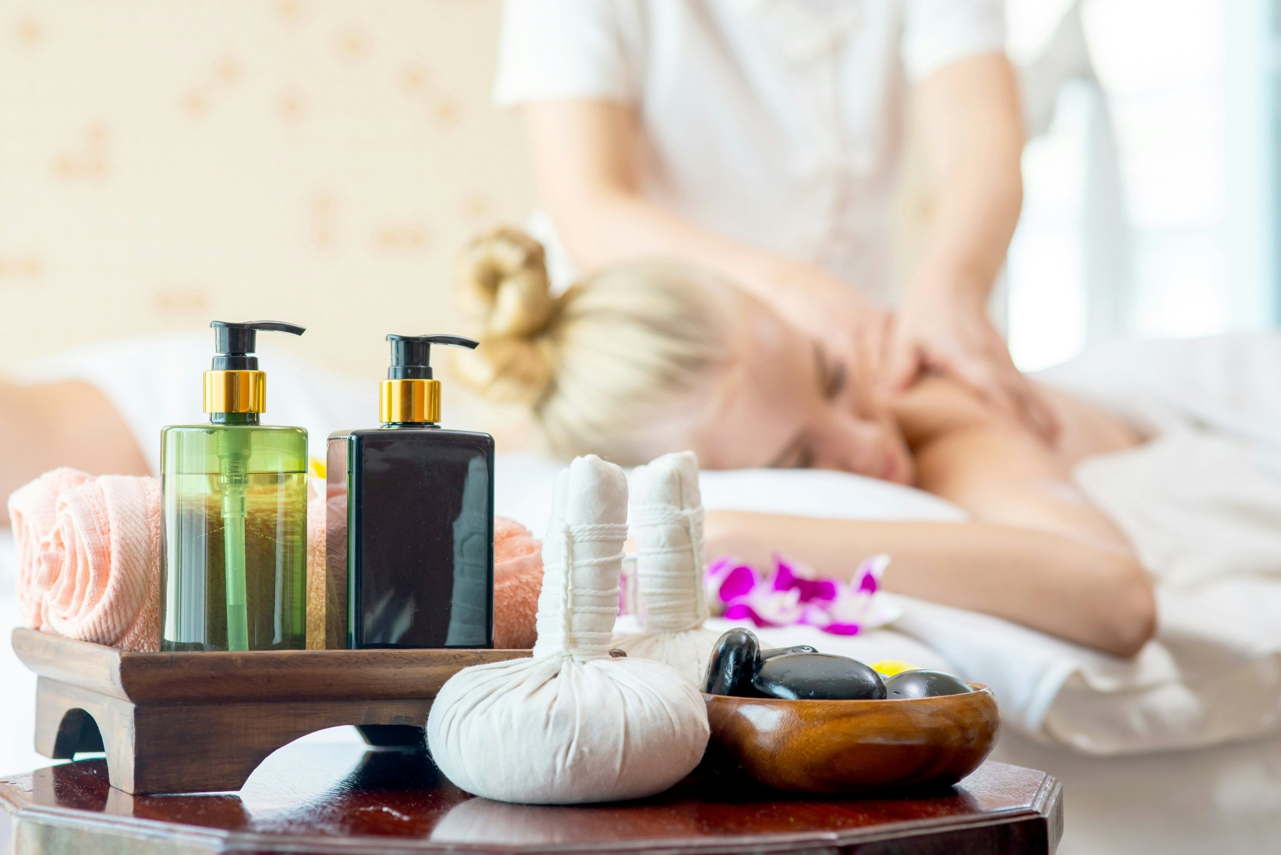Woman receiving a massage with spa products