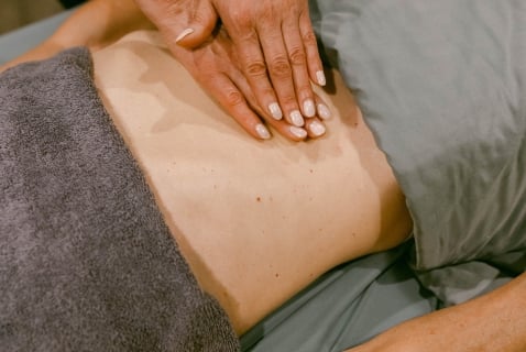 a person's back being massaged