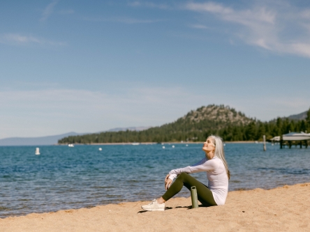 Woman sitting down at the beach