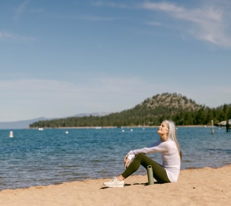 Woman sitting down at the beach