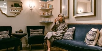 Woman drinking water in spa waiting room
