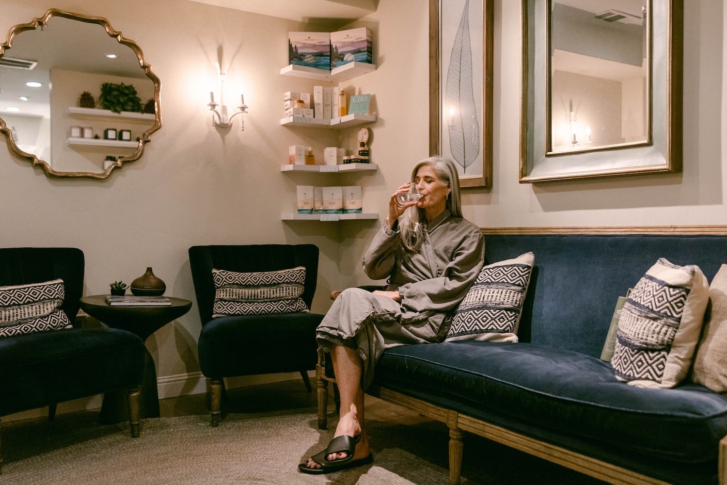 Woman drinking water in spa waiting room