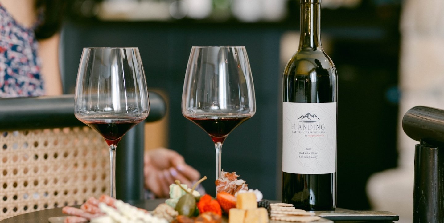 Two glasses of wine with a charcuterie board