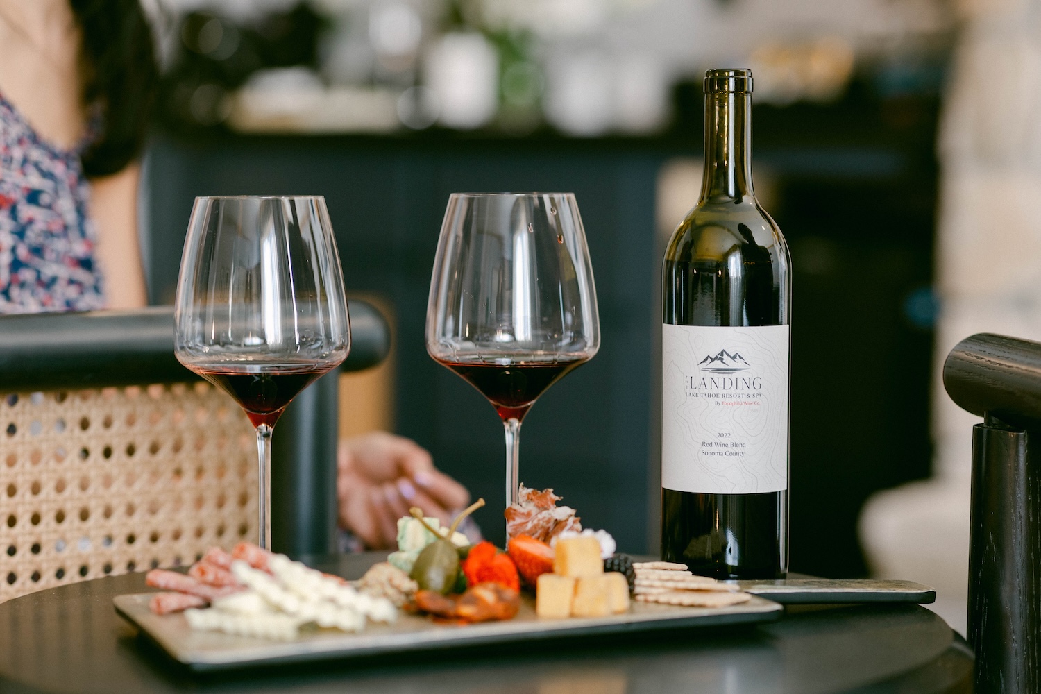 Two glasses of wine with a charcuterie board