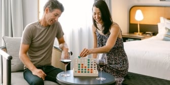 Couple enjoying a game in their room
