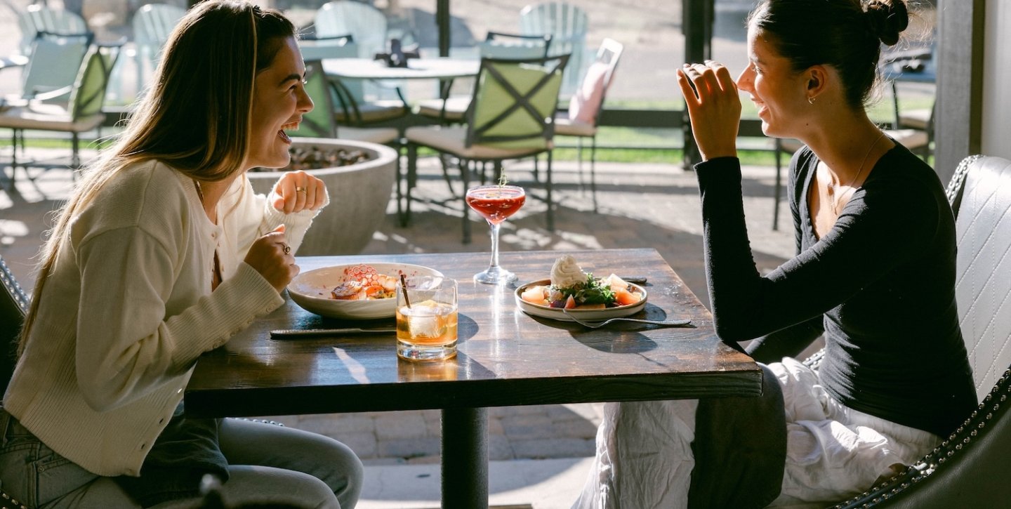Couple laughing while at lunch
