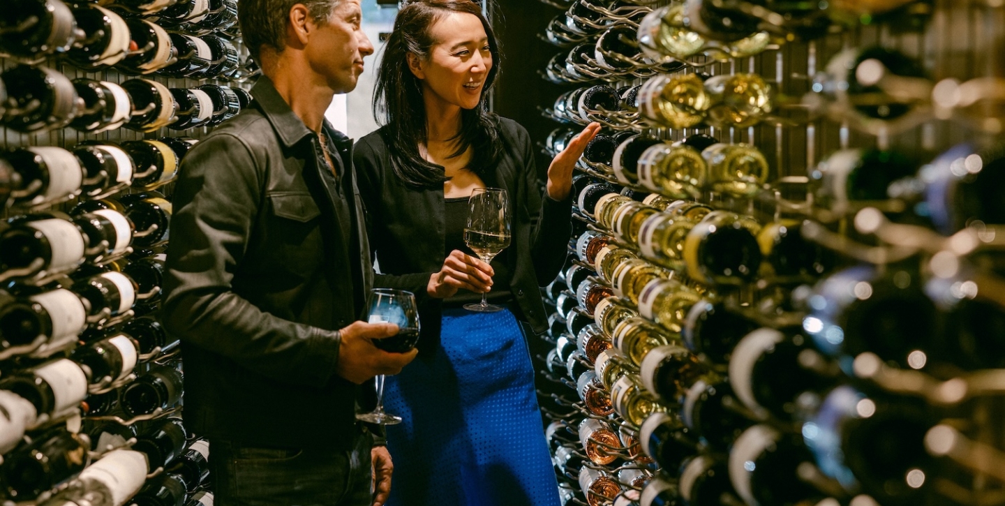 Couple examining different bottles of wine