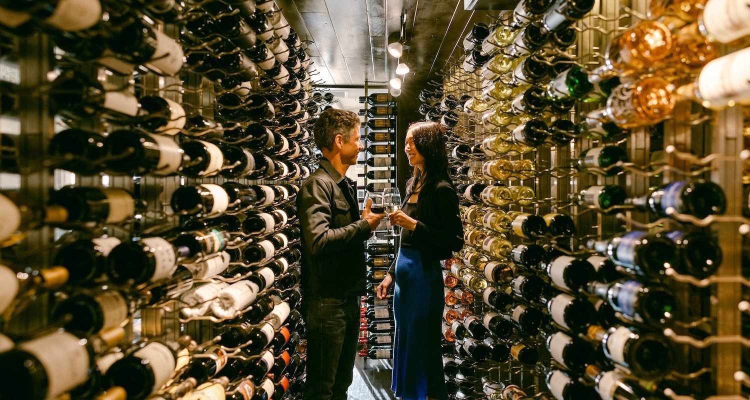 Couple examining different bottles of wine
