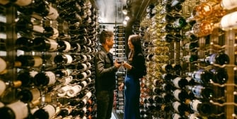 Couple examining different bottles of wine