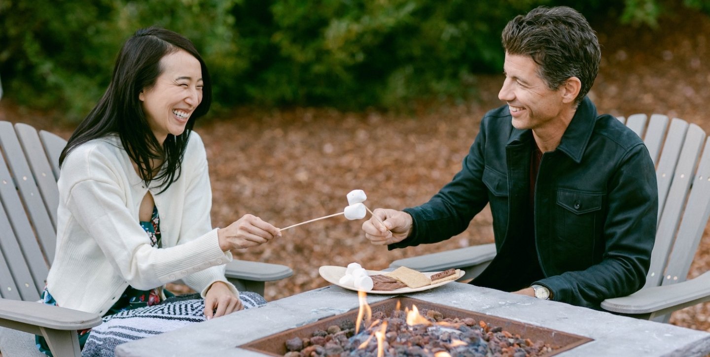 Couple enjoying a smore by the fireplace