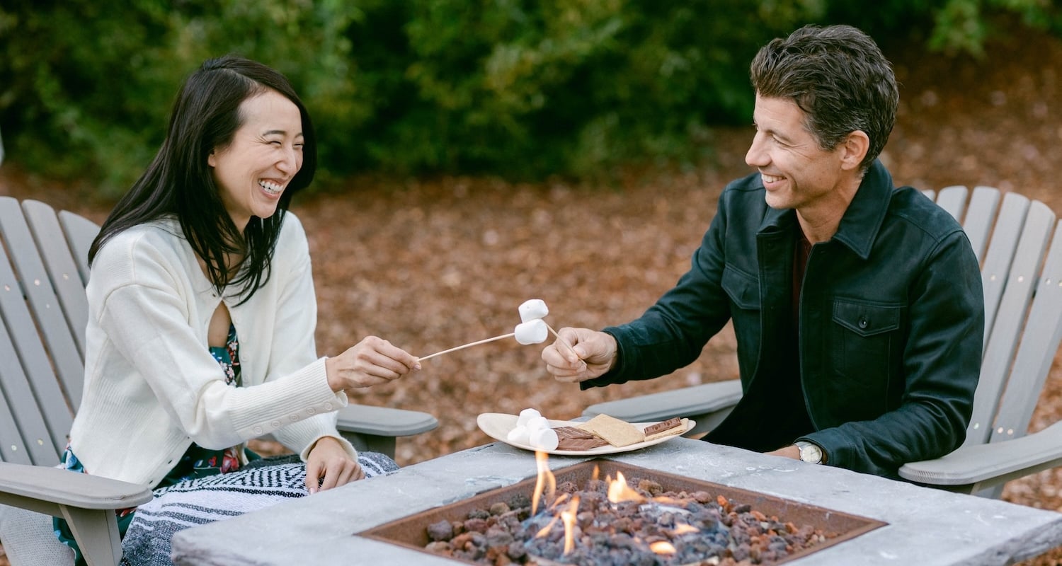 Couple enjoying a smore by the fireplace