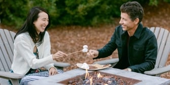 Couple enjoying a smore by the fireplace