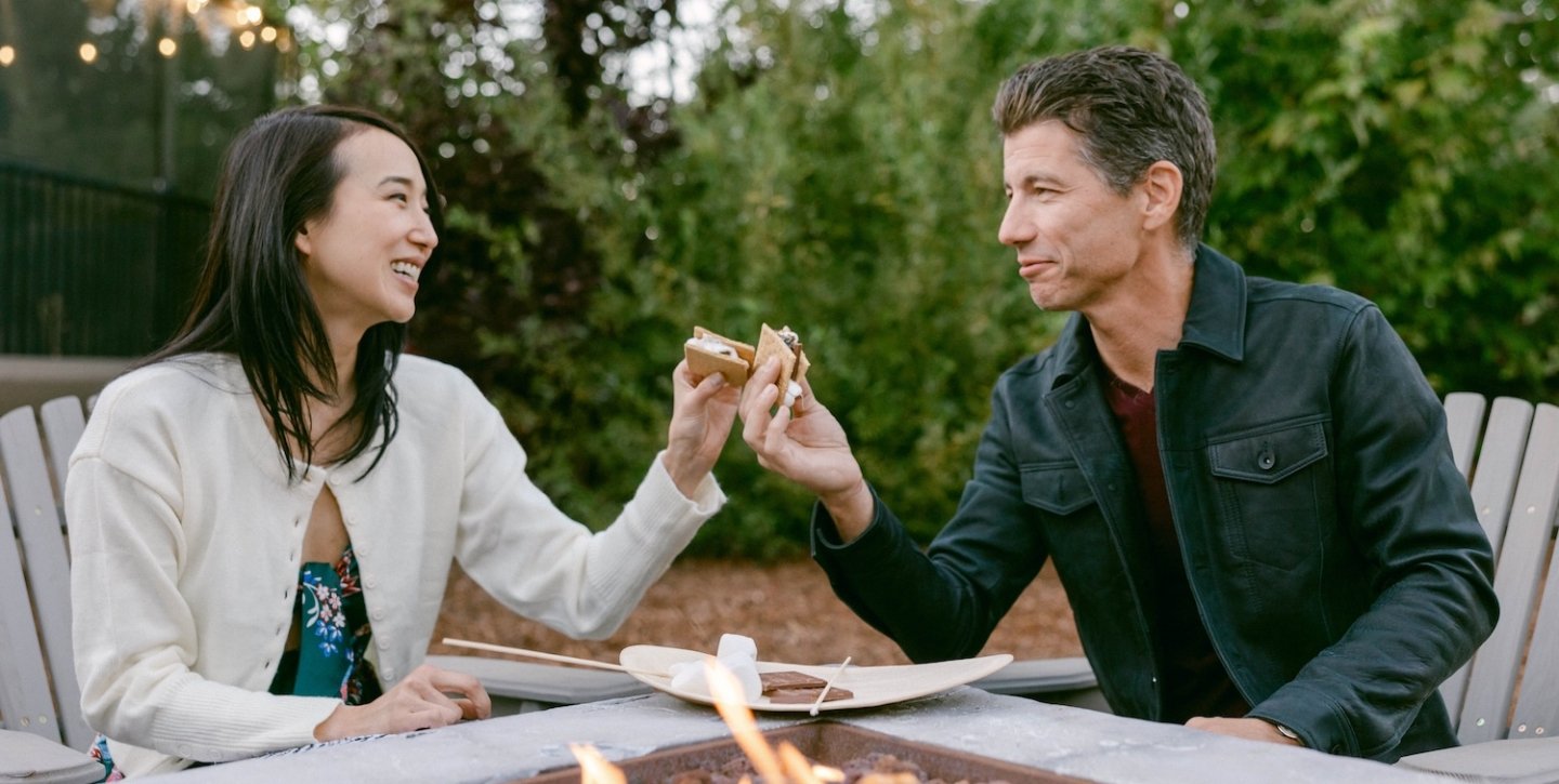 Couple enjoying a smore by the fireplace
