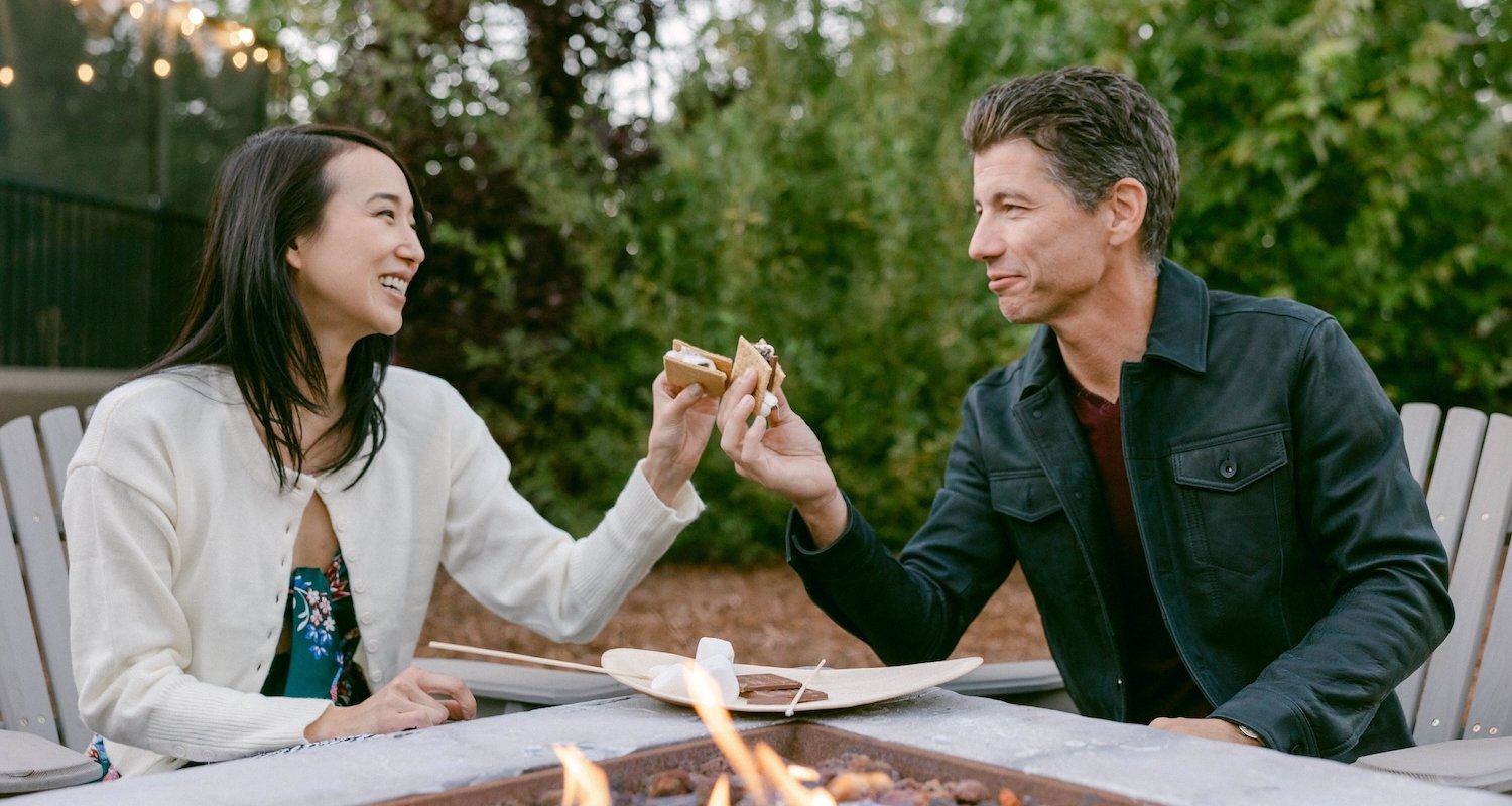 Couple enjoying a smore by the fireplace