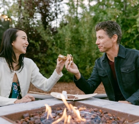 Couple enjoying a smore by the fireplace
