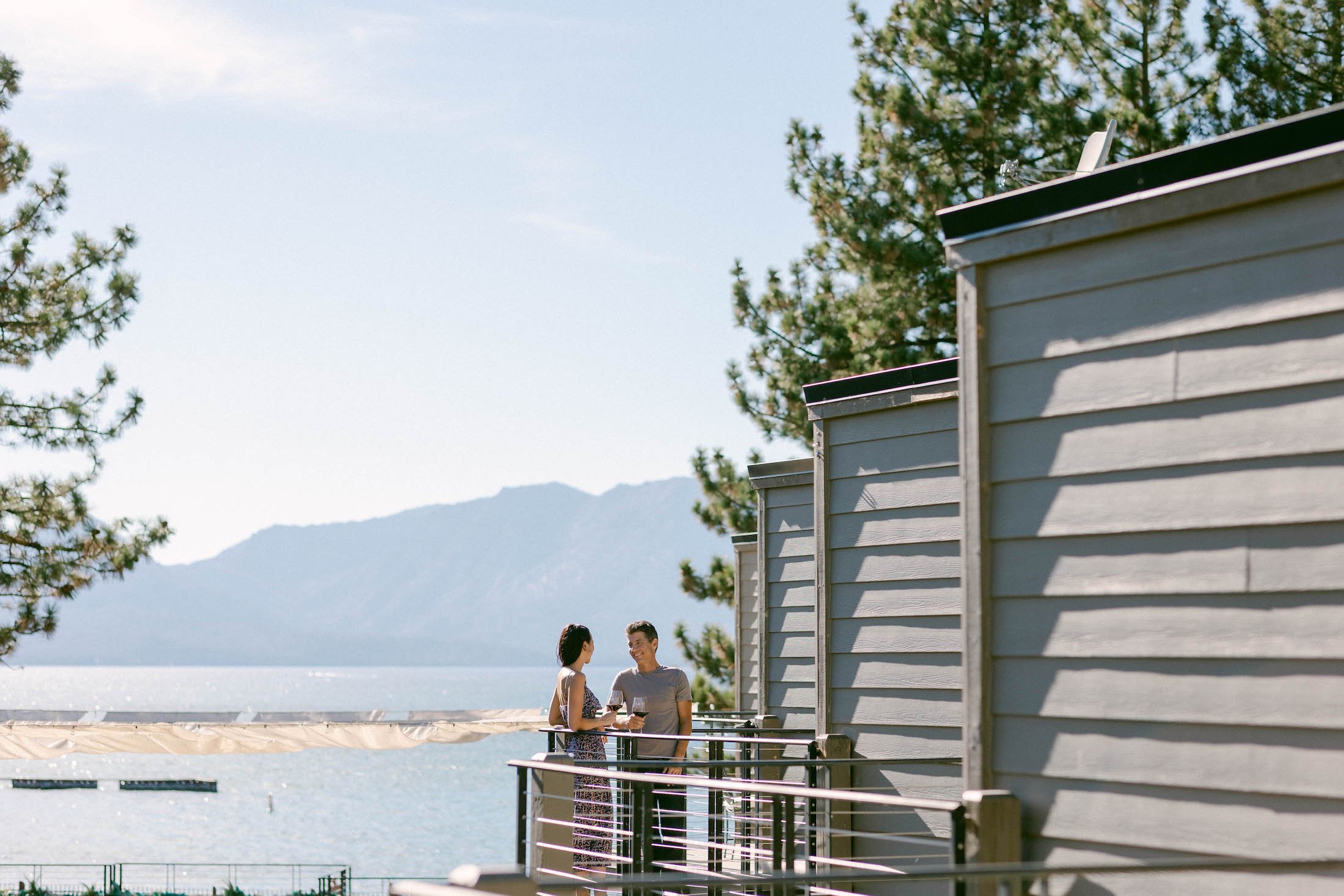 Two people drinking wine on Landing Balcony